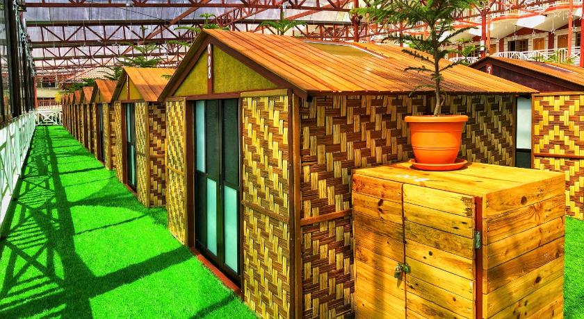 a small wooden structure with a green roof, Kea Garden Mini Chalet in Cameron Highlands