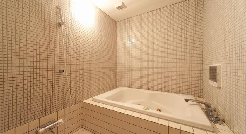 a bathroom with a tub, sink, and mirror, Hotel Fine Matsue Free Parking - Adult Only in Matsue
