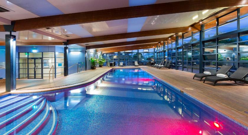 a large swimming pool in a hotel lobby, Novotel Canberra in Canberra