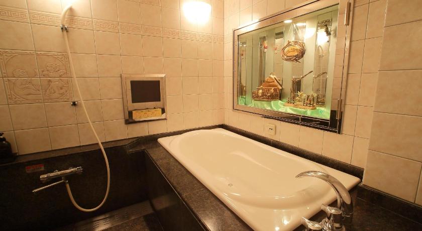 a bathroom with a bathtub, sink and mirror, Hotel Fine Izumo Free Parking - Adult Only in Izumo