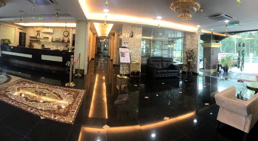 a living room filled with furniture and a large window, AB Inn Hotel in Johor Bahru
