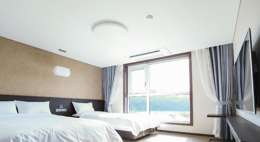 a bedroom with a bed and a window, Jeju Stay in Seongsan in Jeju