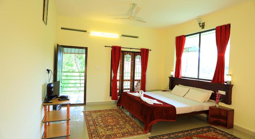 a bedroom with a large bed and a large window, Kerala House - Homestay in Thekkady
