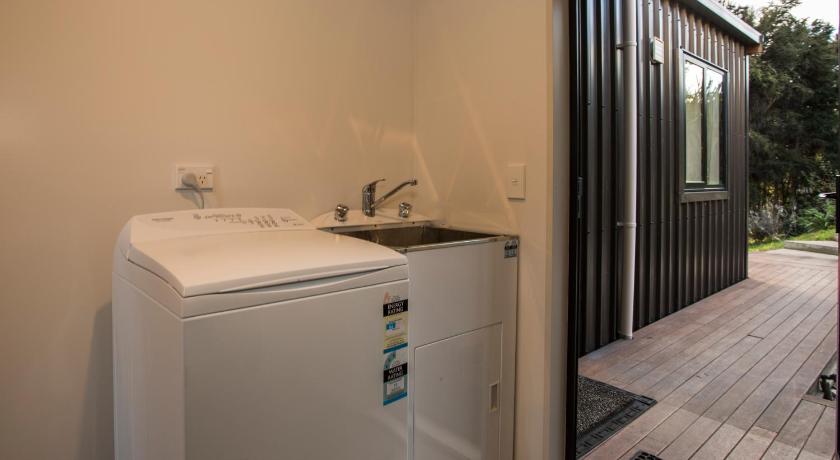 a bathroom with a sink and a refrigerator, private hideaway in Wanaka