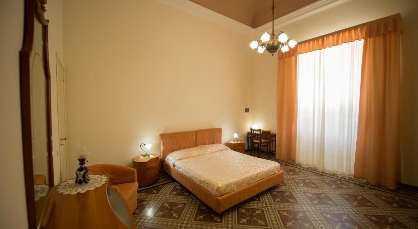 a bedroom with a bed and a dresser, Villa le Torri B&B in Trapani