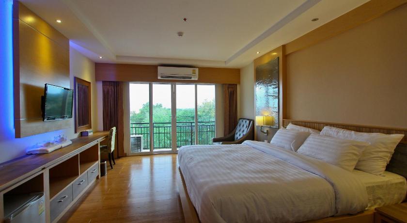 a hotel room with a bed and a television, Kitlada hotel in Udon Thani