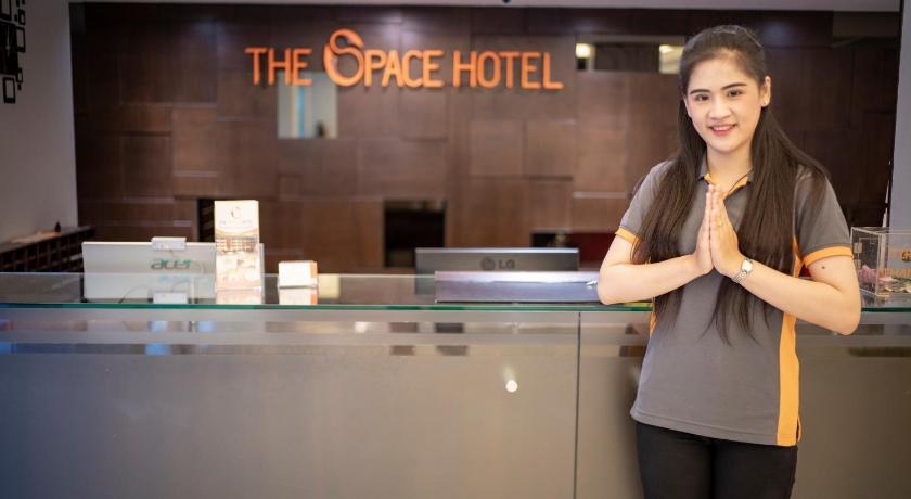 a woman standing in front of a counter in a restaurant, The Space Hotel (SHA Plus+) in Chiang Rai