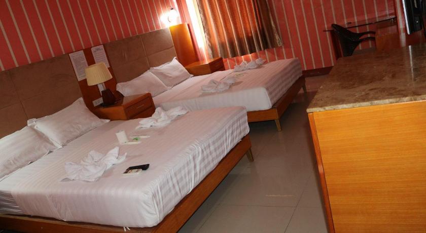a hotel room with two beds and two lamps, Jeamco Royal Hotel- General Santos in General Santos City