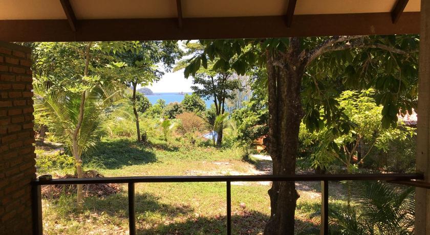 a view from a balcony overlooking a lush green field, Mr Gao, Ko Phayam in Koh Phayam (Ranong)