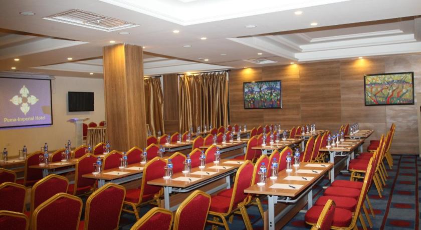 a room filled with tables and chairs filled with chairs, Puma-Imperial Hotel in Ulaanbaatar