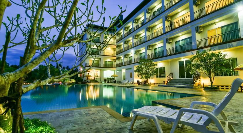 a hotel room with a balcony overlooking the ocean, Southgate Residence Hotel (SHA Extra Plus) in Chumphon