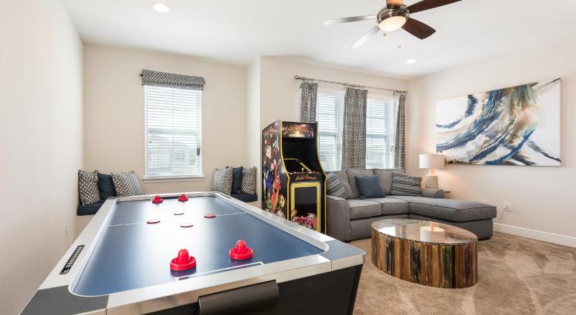 a living room filled with furniture and a fire place, Lovely Home Near Disney with Private Pool, Game Room & Resort Amenities - 7402M in Orlando (FL)
