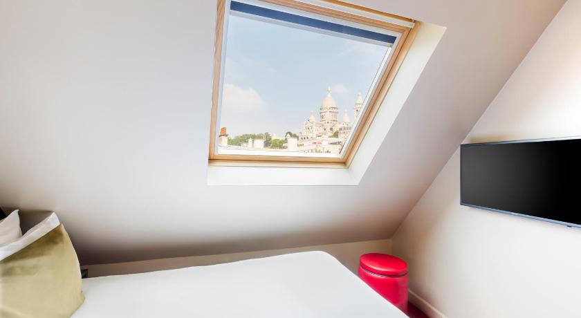 a room with a bed and a window, Best Western Hotel Le Montmartre Saint Pierre in Paris