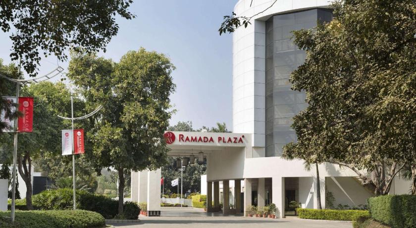 a large building with a sign on the side of it, Ramada Plaza By Wyndham Jhv Varanasi in Varanasi