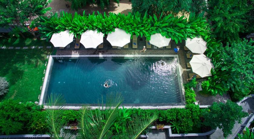 a garden area with a pool of water and plants, Hoi An Garden Palace Hotel and Spa in Hoi An