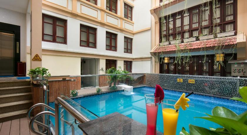 a pool with a pool table and chairs in it, Hanoi Nostalgia Hotel & Spa in Hanoi