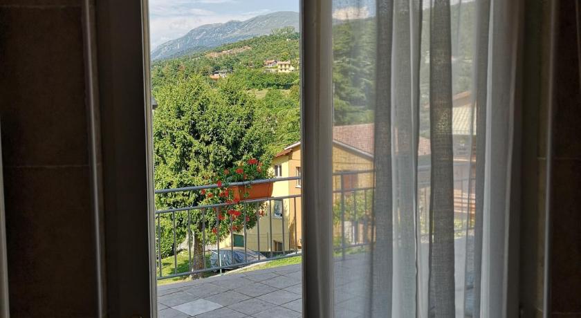 a view through a window of a house, Corte Moreno in San Zeno di Montagna