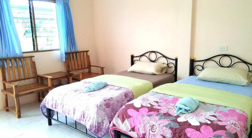 a bed room with two beds and a desk, Peace Pool Resort in Sisaket