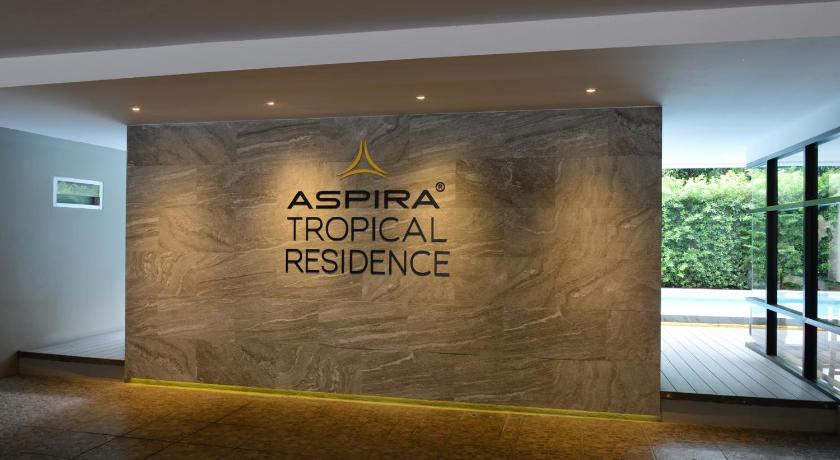 a building with a sign on the side of it, Aspira Tropical Residence Thong Lor in Bangkok