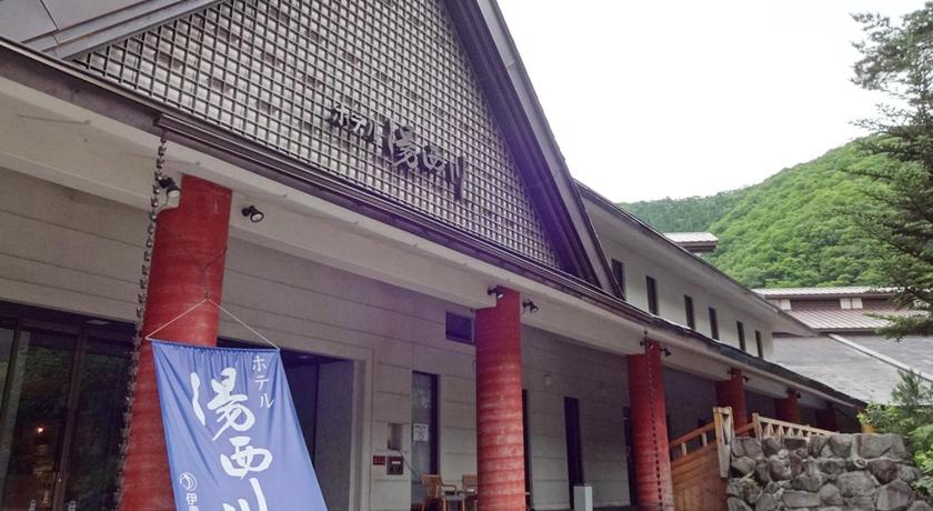 a building with a sign on the front of it, Hotel Yunishigawa in Nikko