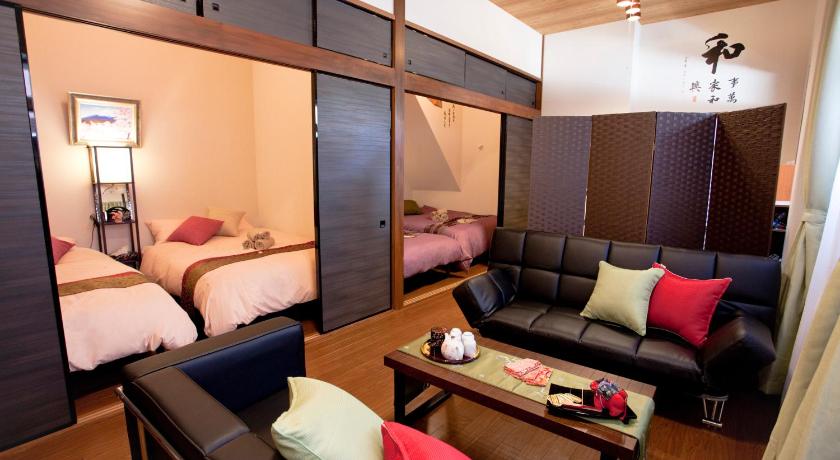 a hotel room with a bed, couch, chair and a television, D3. Sensoji 3min, AsakusaSta 10min, Wifi, Max10 in Tokyo