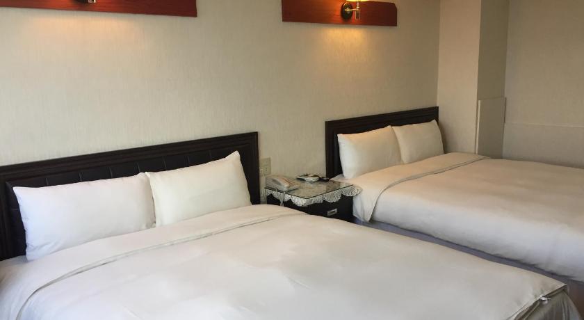 a hotel room with two beds and two lamps, King Lo Tung Hotel in Yilan