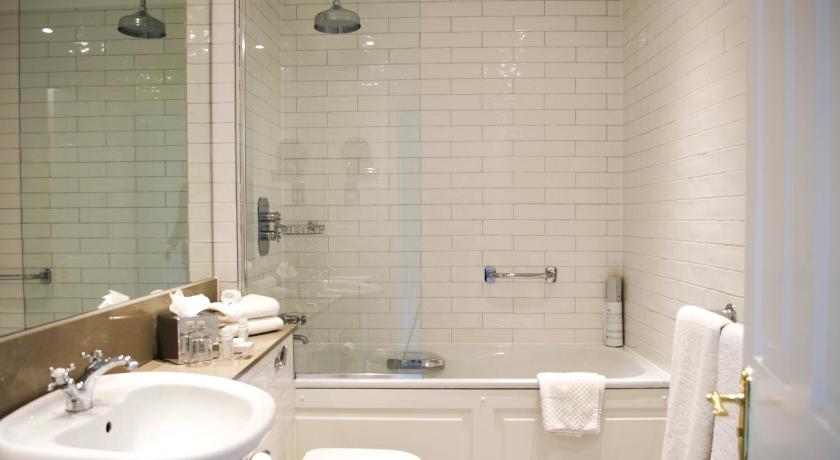 a bathroom with a sink, toilet and bathtub, The Bonham Hotel in Edinburgh