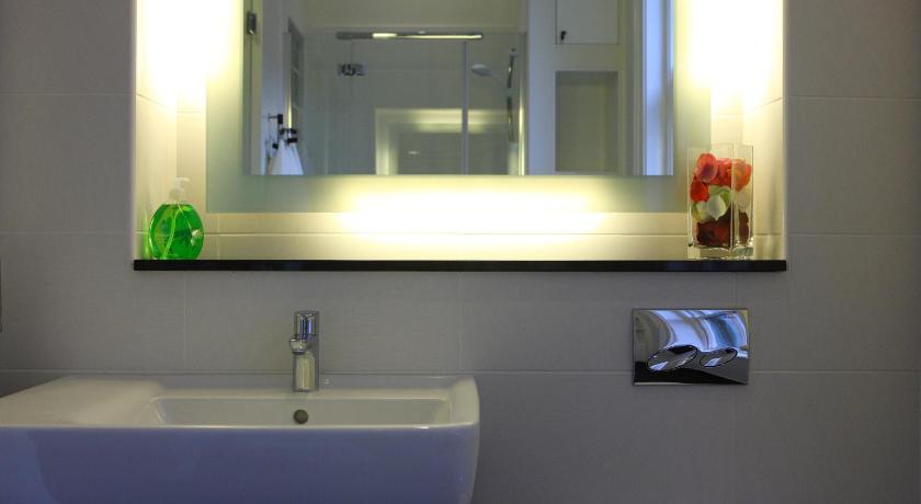 a bathroom with a sink, mirror, and soap dispenser, The Merchant House in Dublin