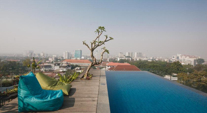 a patio area with a pool and a balcony overlooking a city, Janevalla Bandung in Bandung
