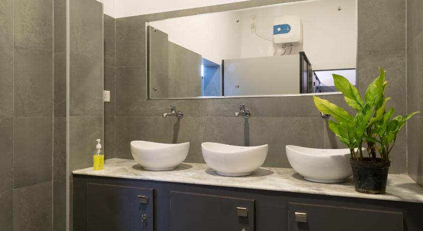 a bathroom with two sinks and a large mirror, Micasa Hostels in Pondicherry