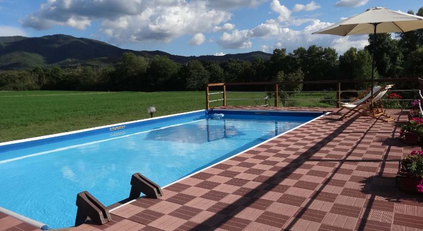 a person sitting on a bench in front of a pool, Valle degli Arci in Castel Madama