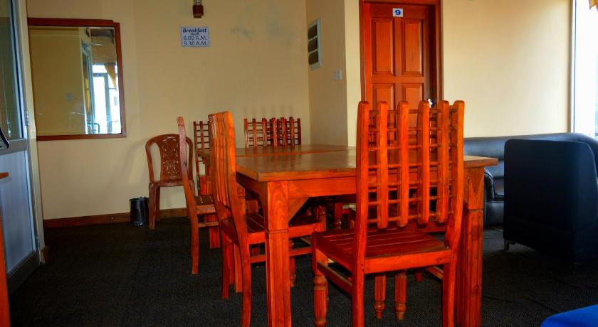 a dining room table with chairs and chairs, Guest House Hill Paradise in Nuwara Eliya