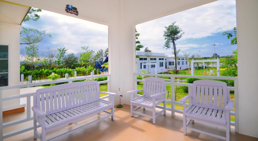 a living room filled with furniture next to a blue wall, Blue Sky Villa Khaoyai Resort in Khao Yai
