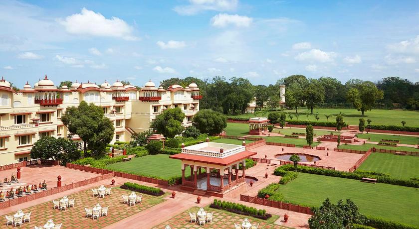 a large building with a lot of green grass, Jai Mahal Palace Hotel in Jaipur