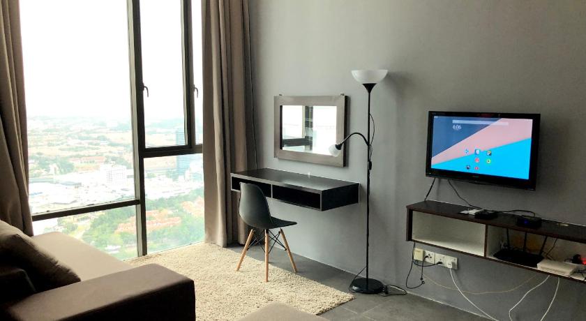 a flat screen tv sitting on top of a stand in a living room, Empire Damansara Residence Suites in Kuala Lumpur