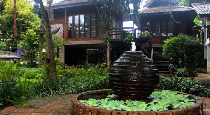 a fire hydrant in the middle of a garden, Baan Tawan Guesthouse in Pai