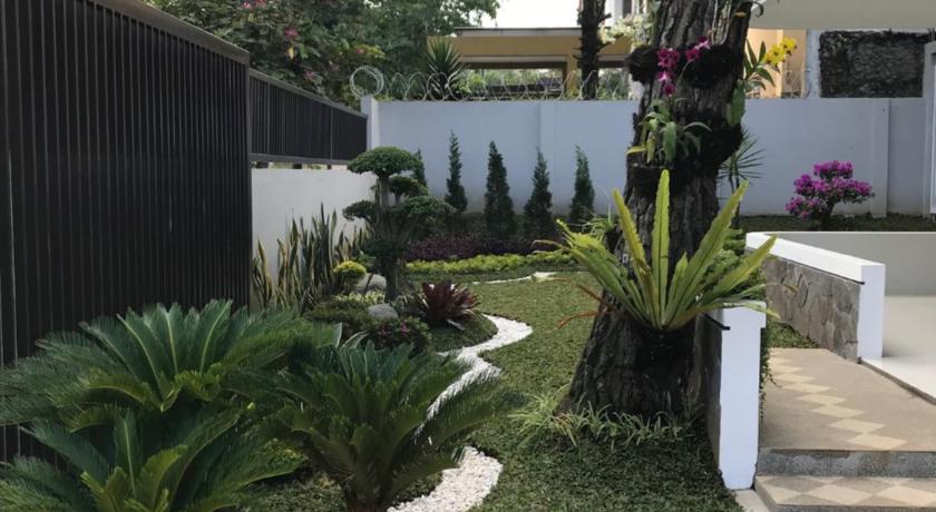 a garden with flowers and plants in it, Kensington Villa in Bandung