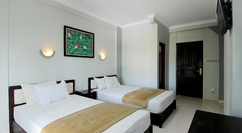 a hotel room with two beds and two lamps, Bugis Asri Hotel in Yogyakarta