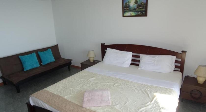 a bed in a room with a white bedspread, VIP Condochain Rayong in Rayong