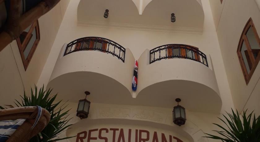 a large building with many windows and balconies, Al Hambra Hotel in Luxor