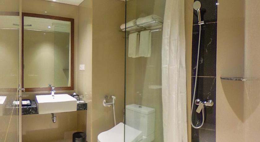 a bathroom with a shower, sink, and tub, Great Diponegoro Hotel Surabaya in Surabaya