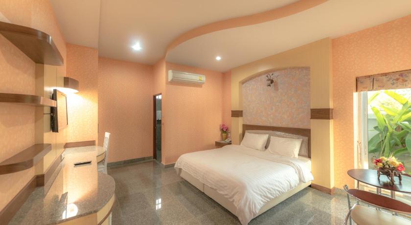a hotel room with a large bed and a large window, Martina Hotel (SHA Extra Plus) in Surin