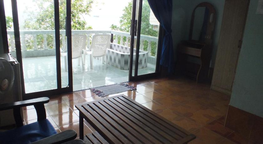 a wooden bench sitting in front of a large window, Queen Resort in Ko Tao