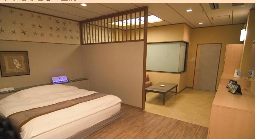 a bedroom with a bed and a desk, Hotel Very Matsusaka (Adult Only) in Tsu