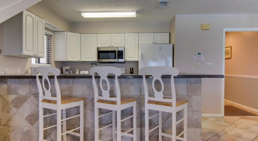 a kitchen with a stove top oven and a microwave, Crystal Village B-15 in Destin (FL)
