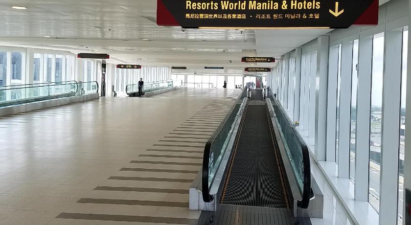 an airport terminal with a lot of luggage, 101 Newport Blvd Condotel in Manila