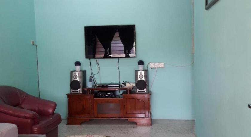 a living room filled with furniture and a tv, Homestay Ustaz in Taiping