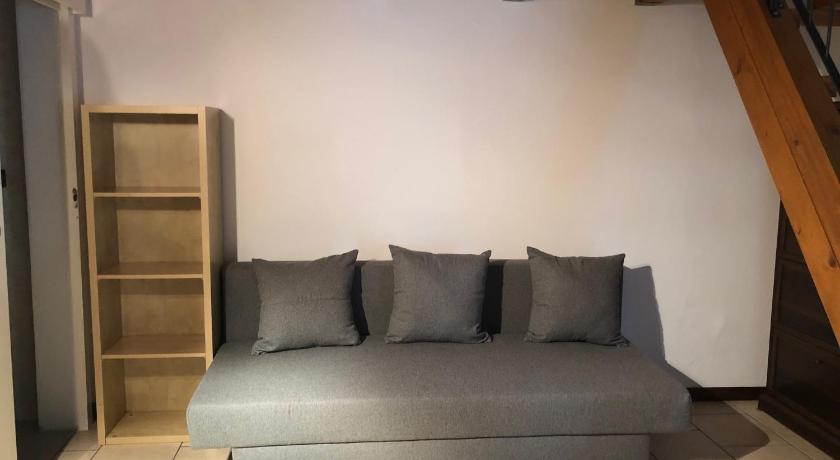 a white couch sitting in a room next to a wall, Pizzardi39 - The Place Apartments in Bologna