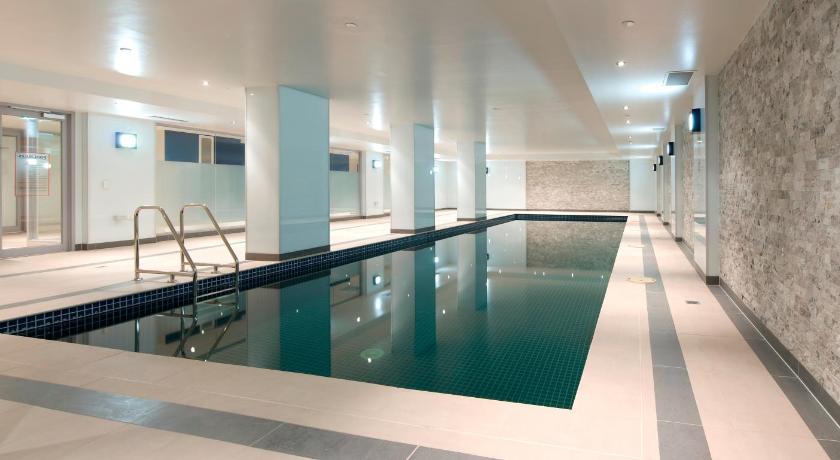 a large swimming pool in a large room, Atlantis Hotel Melbourne in Melbourne