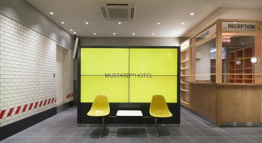 a room with two yellow chairs and a yellow wall, MUSTARD HOTEL SHIBUYA in Tokyo